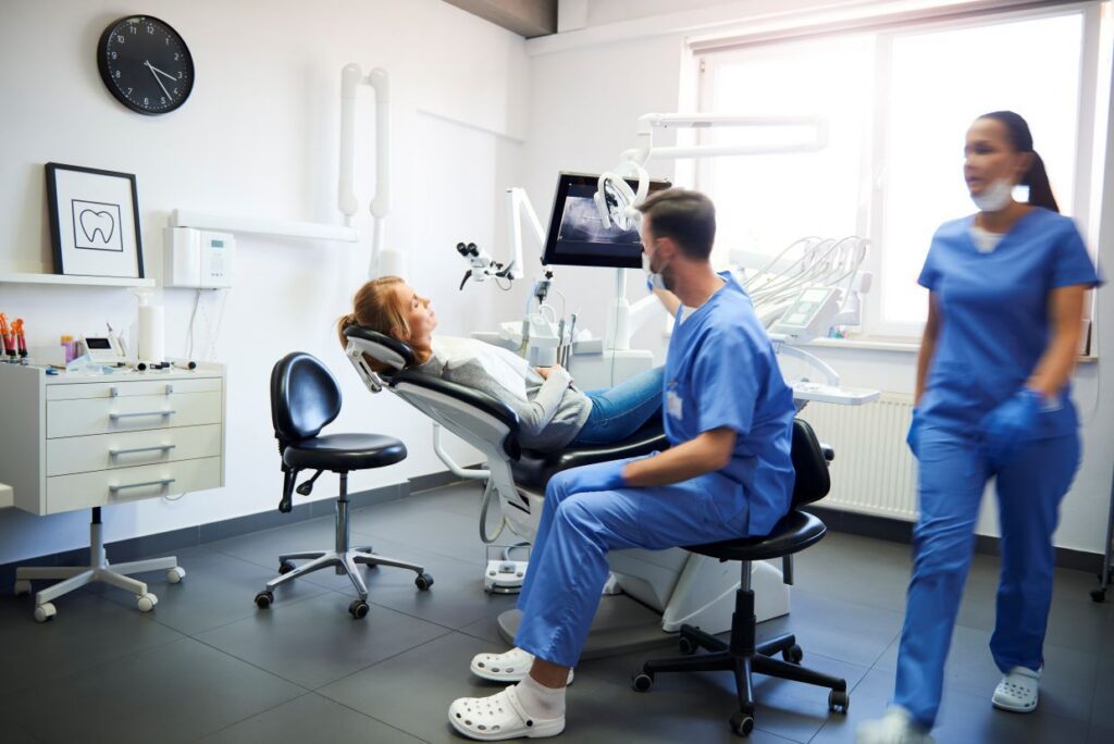 Dentist working in a modern dental treatment room in Dallas, Texas.