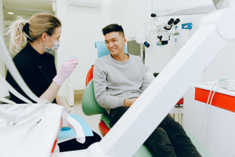 Dentist discussing treatment options with a patient during a consultation.